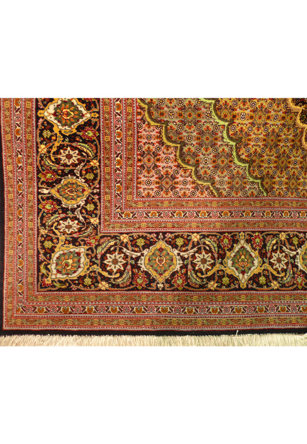 Corner detail of the black main border with gold, green and ivory palmettes and rosettes