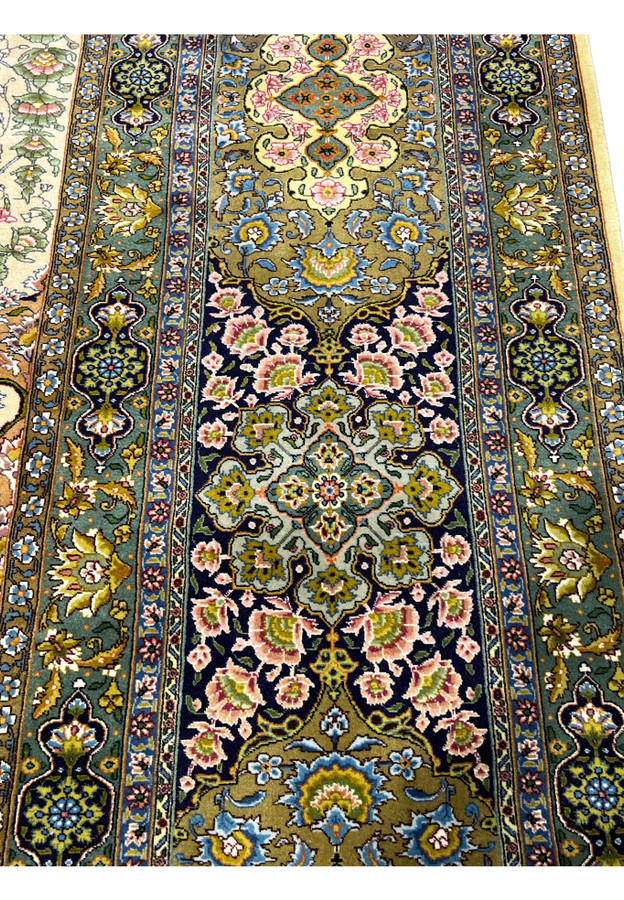 Navy main border with a floral vine of palmettes and roses in gold, pink and blue