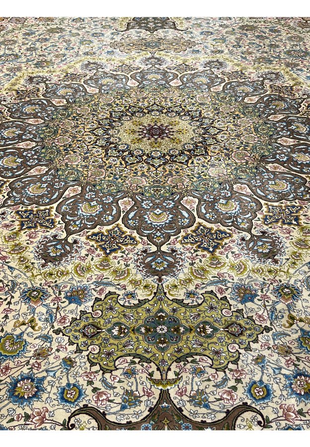 Detailed heart of the medallion showing layered floral tracery and silk highlights in the Tabriz weave