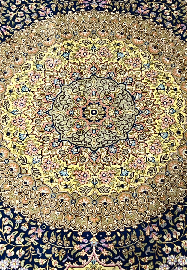 Close look at the medallion, layered rosettes, pink blossoms and scrolling vines in pure silk