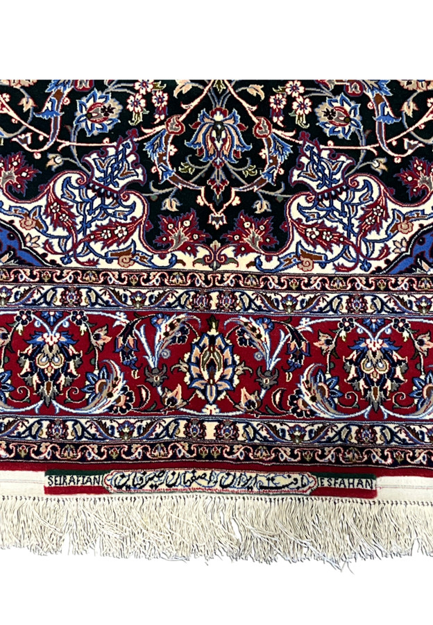 Woven signature cartouche reading Seirafian and Esfahan on the end panel of the rug