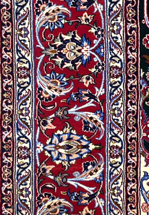 Red main border close-up with cobalt palmettes, ivory meander guards and fine silk highlights