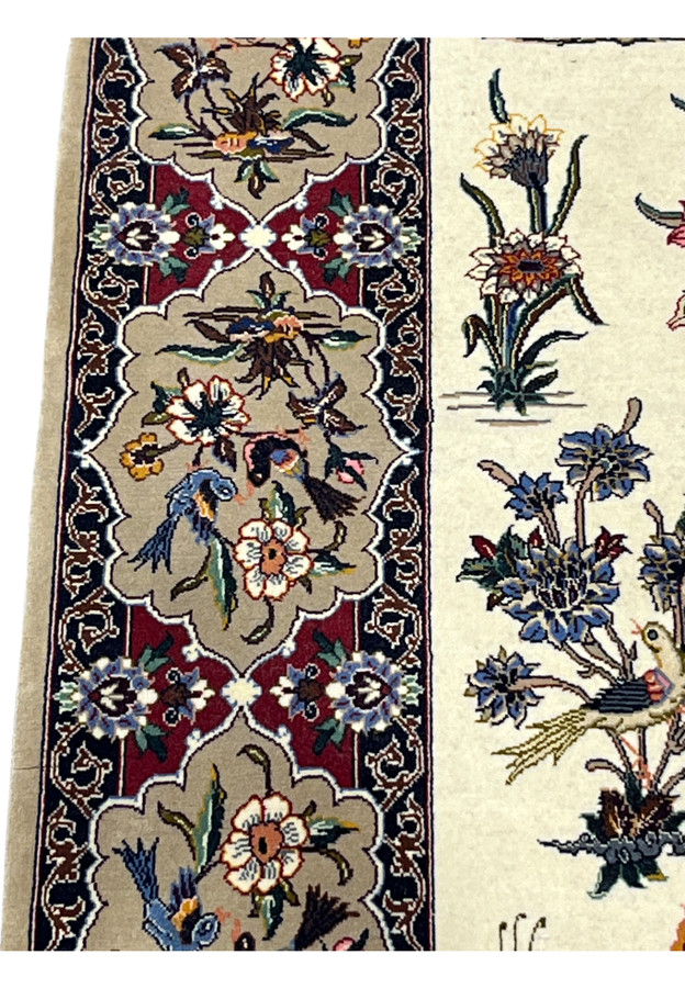 Border close-up with a blue bird, white blossoms and gold butterfly inside one cartouche