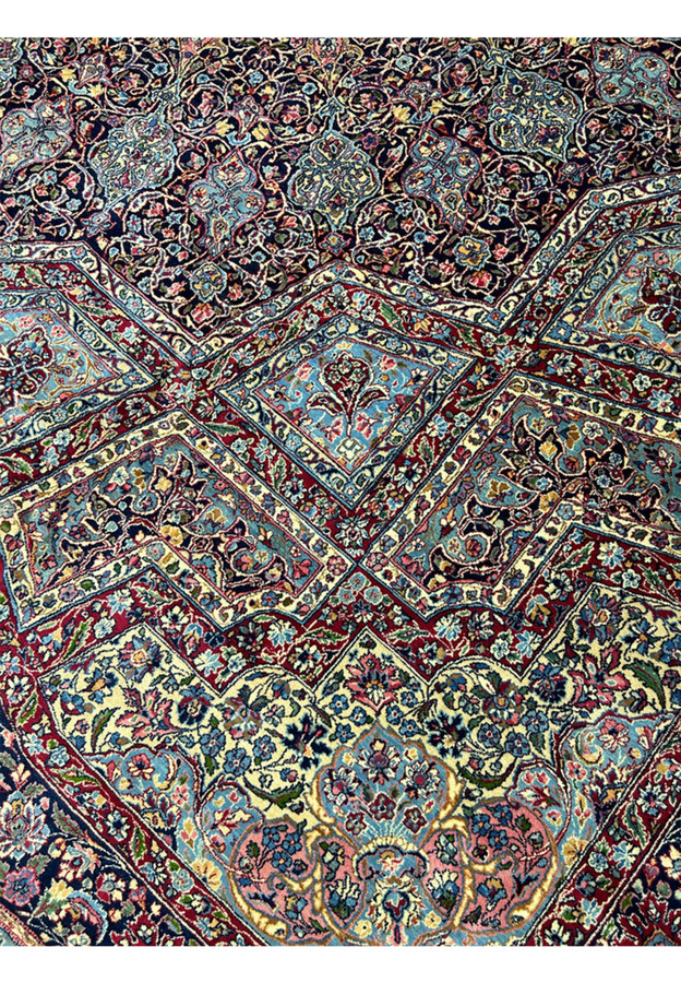Sky blue cartouche panels set into the red framework of this square palace size rug