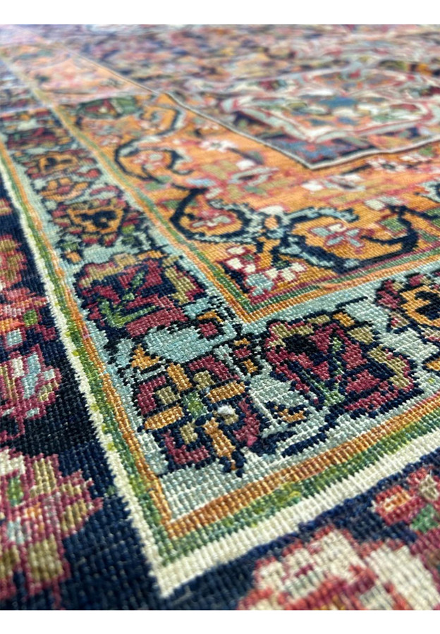 Macro of century old wool in red, orange and sky blue with full 3/8 inch pile height