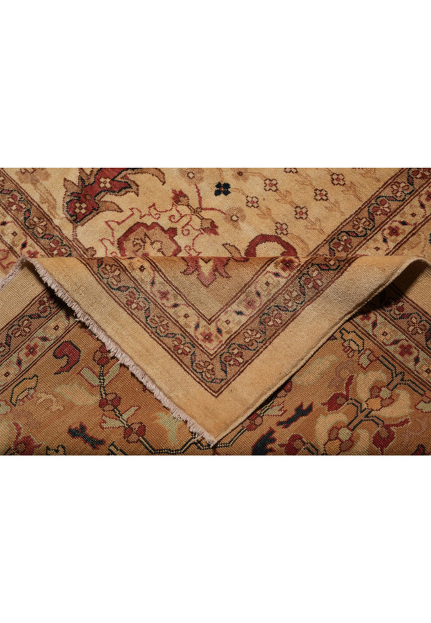 Fold in cream wool-on-cotton Peshawar rug showing ply and edge construction quality