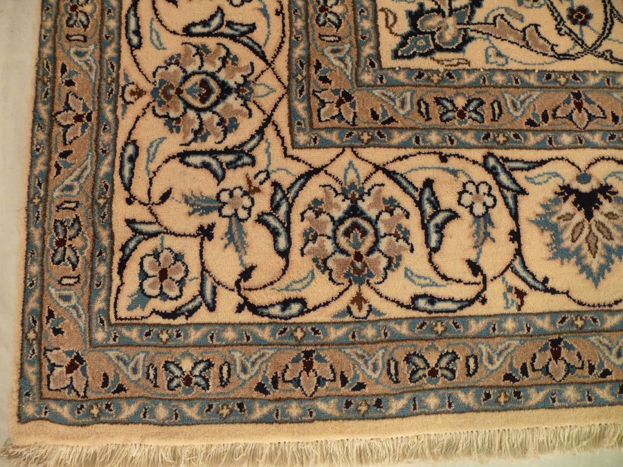 Camel main border and blue guard bands meeting at the corner, ivory fringe below