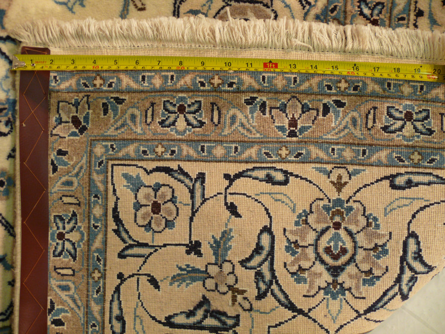 Reverse side of the ivory Nain, dense knot rows and natural fringe at the finished end
