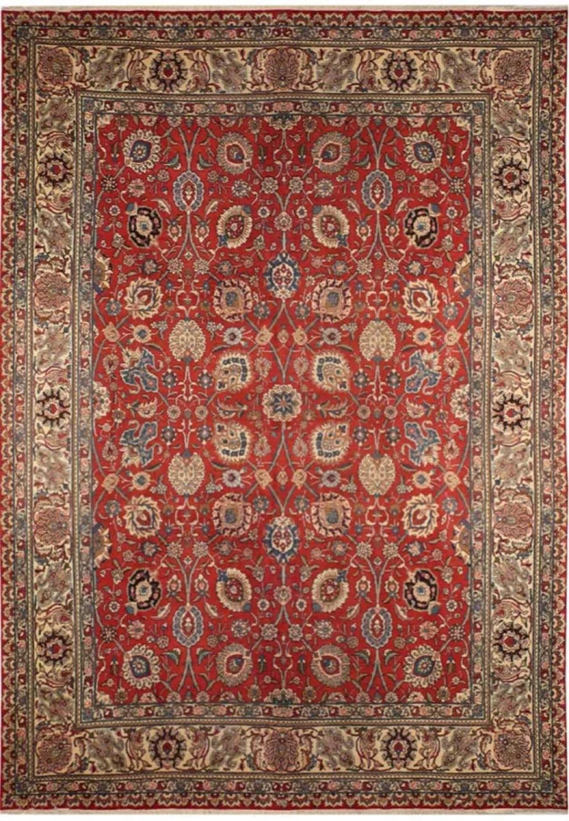 Full view of the vintage 10 x 13'5 Persian Tabriz rug with rusty red allover floral field
