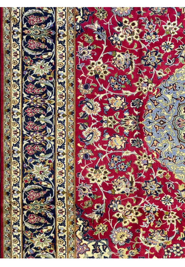 Detailed view of the border on Persian Isfahan Rug featuring small medallions and floral patterns.