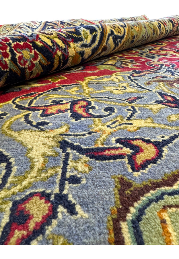 Rolled Persian 10x13 Isfahan Rug showing texture and intricate patterns up close