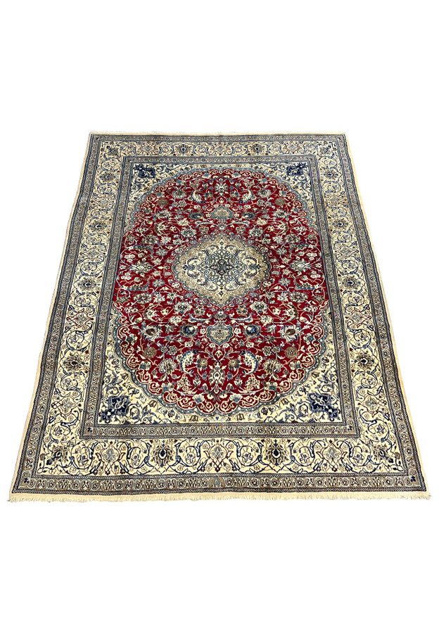 Top view of red Persian Nain 9LA rug with ivory central medallion, navy floral details, and balanced symmetrical layout