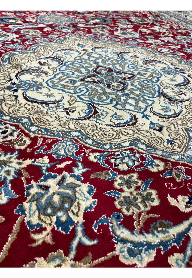 Foundation close-up of Persian Nain rug revealing tight hand knotted structure and fine wool and silk weave