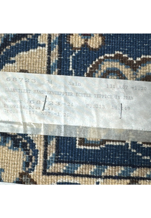 Rug tag displaying authenticity of 2'11" x 4'6" Persian Nain rug.