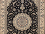 This picture showcases a Persian Nain wool and silk rug, measuring 8' x 11', with a close-up of its beautiful medallion in the center. The image also displays the intricate details of the middle of the rug, highlighting its exceptional quality and craftsmanship. This rug is a perfect addition to any space, bringing elegance and sophistication to your home decor.