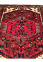 Midfield detail of an antique Persian Hamedan tribal rug featuring abstract symbols, saturated red wool, and expressive hand-knotted village design