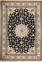 Full view of 8′1″ × 11′4″ Persian Nain rug with beige field and navy medallion