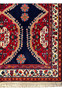 Detailed pattern of a Persian Qashqai rug showcasing the vibrant red medallions, blue backdrop, and a variety of floral and geometric shapes