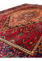 Border detail of a 4x6 Persian Gholtogh rug with intricate navy and red designs.