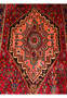 Detailed view of the central medallion design of a Persian Gholtogh rug