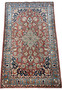 Angled perspective of a 3x5 Antique Mashad Rug, emphasizing the depth of color and traditional design elements.