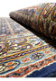 Another angle showing the Persian Moud Rug's thick pile and intricate designs, with the edge slightly rolled.