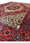 Angle shot highlighting the plush pile and vivid colors of the Persian Gholtogh rug