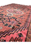 Angled perspective of the 3'5 x 6'5 Persian Baluch rug showing the texture and color variations in the weave
