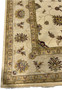 Close-up of the rug's edge and corner detailing the precise border patterns.