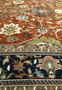 Close-up of the handwoven patterns and floral motifs in the field of an Oriental Serapi Palace Rug