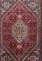 Close-up of the Persian Bijar Rug's central design, with deep reds and intricate indigo accents