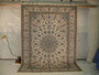 Angled view showing navy medallion with ivory and sky blue highlights on Persian Nain rug Angled view showing navy medallion with ivory and sky blue highlights on Persian Nain rug