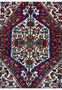 A close-up of the central design of a Persian Bijar rug, highlighting the detailed weaving and rich color palette.