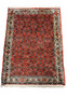 An overall view of a vintage Bijar rug, showcasing its intricate all-over design and vibrant red color.