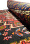 Partial view of the Persian Gholtogh rug's edge, illustrating the intricate border design and the fine craftsmanship of the weave.