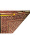 Partial view of a Persian Bijar rug showing the edge and fringe detail alongside a measuring tape for scale