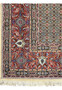 Corner detail of the Persian Moud Rug, where the intricate border meets the fringe, displaying the craftsmanship of the weave