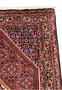 Elegant side view of a rolled 3x5 Persian Bidjar Rug, emphasizing the rug's thickness and the quality of its tight weave