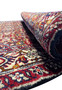 Side view of a rolled 3 x 4'7" Persian Bidjar rug, illustrating the thickness and compact weaving style typical of Bidjar craftsmanship