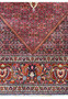 Angled view of the Bijar rug's border, with a focus on the detailed floral motifs and precise weaving.