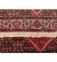 Edge detail of the Persian Bijar rug, displaying the fringe and the density of the weave.