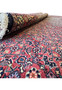 A section of a Persian Bidjar rug with a close-up on the detailed floral motifs and the dense, luxurious pile