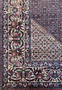 Another angle highlighting the side border of the 11'6x11'6 Persian Bijar square rug, capturing the density of the weave and the vivid interplay of colors