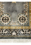 Art Deco rug corner detail highlighting the harmonious blend of gold, black, and gray tones with a tasseled edge.