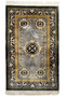 Elegant Art Deco wool and silk rug with black borders and intricate golden designs on a gray background