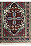 A close-up of the Persian Tabriz rug's central medallion, illustrating the fine weave and the rich color combination of the design with precise details