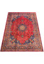 Angled view of the Persian Mashad rug highlighting its detailed border and floral motifs.