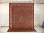 Persian Bijar rug 8x11 hung vertically to show scale, symmetry, and sharp detail under studio lighting