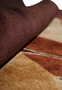 Rolled detail of thick wool pile in modern rug design
