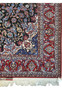 Intricate floral corner and border of signed Persian Isfahan Seirafian rug with crimson, ivory, and Persian blue details.